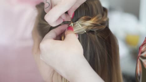 girl having her hair done by hair stylist