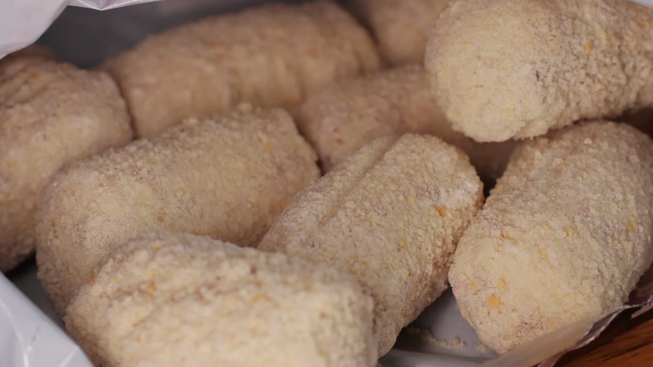 Portuguese croquettes on wooden desk close-up macro. Breaded croquette of fish, potatoes and ham. Man cooking spanish food. . High quality 4k footage