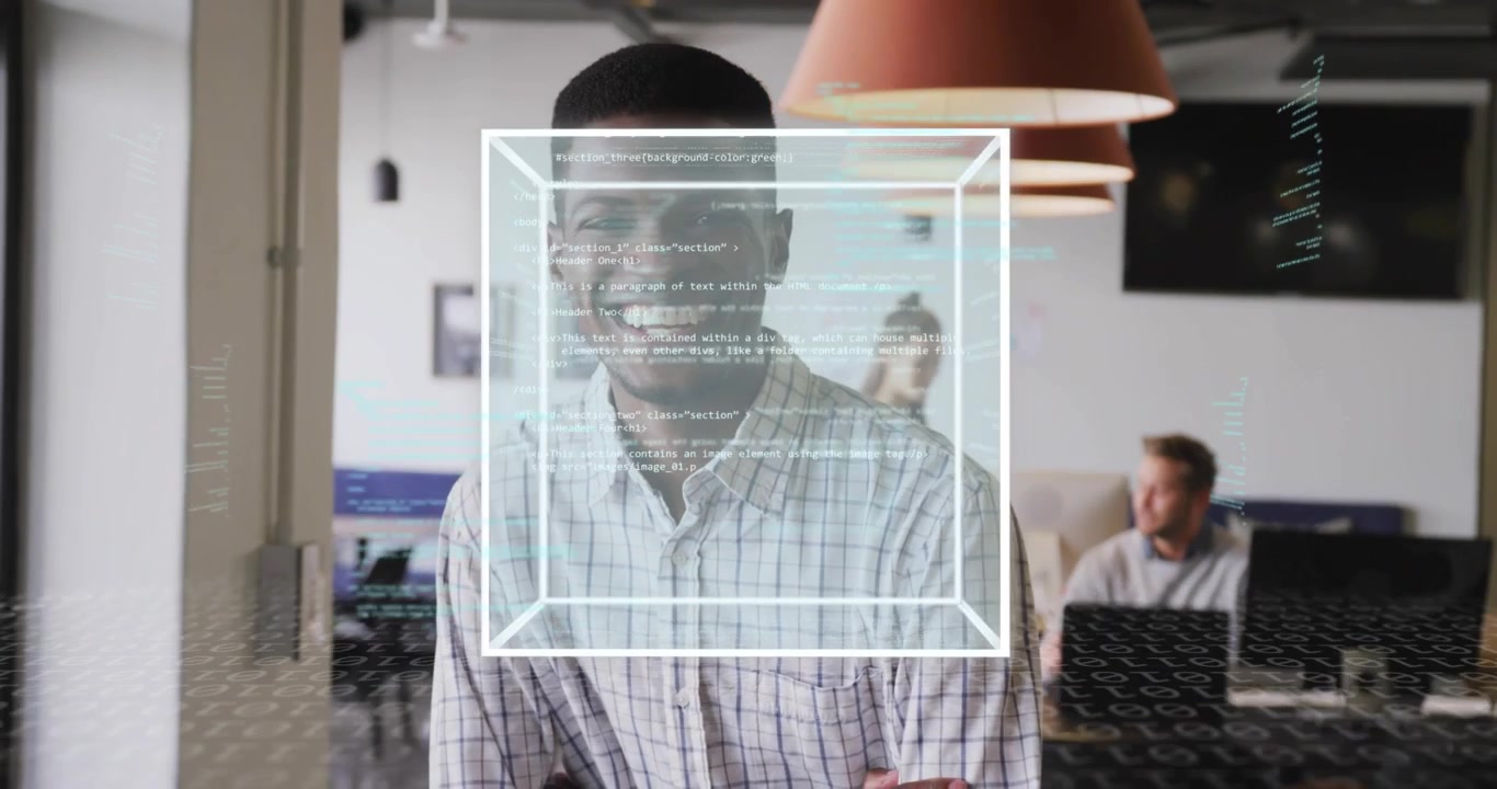 Coder smiling wireframe cube materializing rotating technology code panel with colleagues behind
