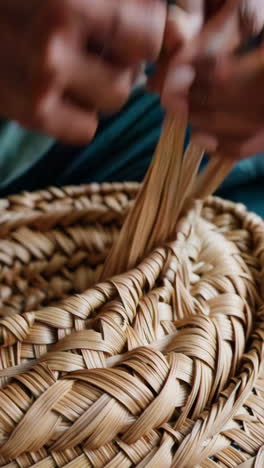 close up of someone weaving a basket