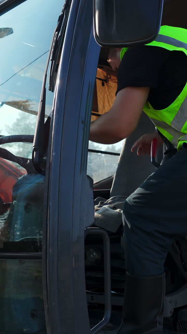 Construction Worker Entering Excavator