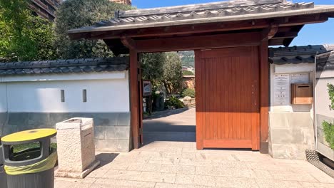 wooden gate gradually opens to reveal pathway