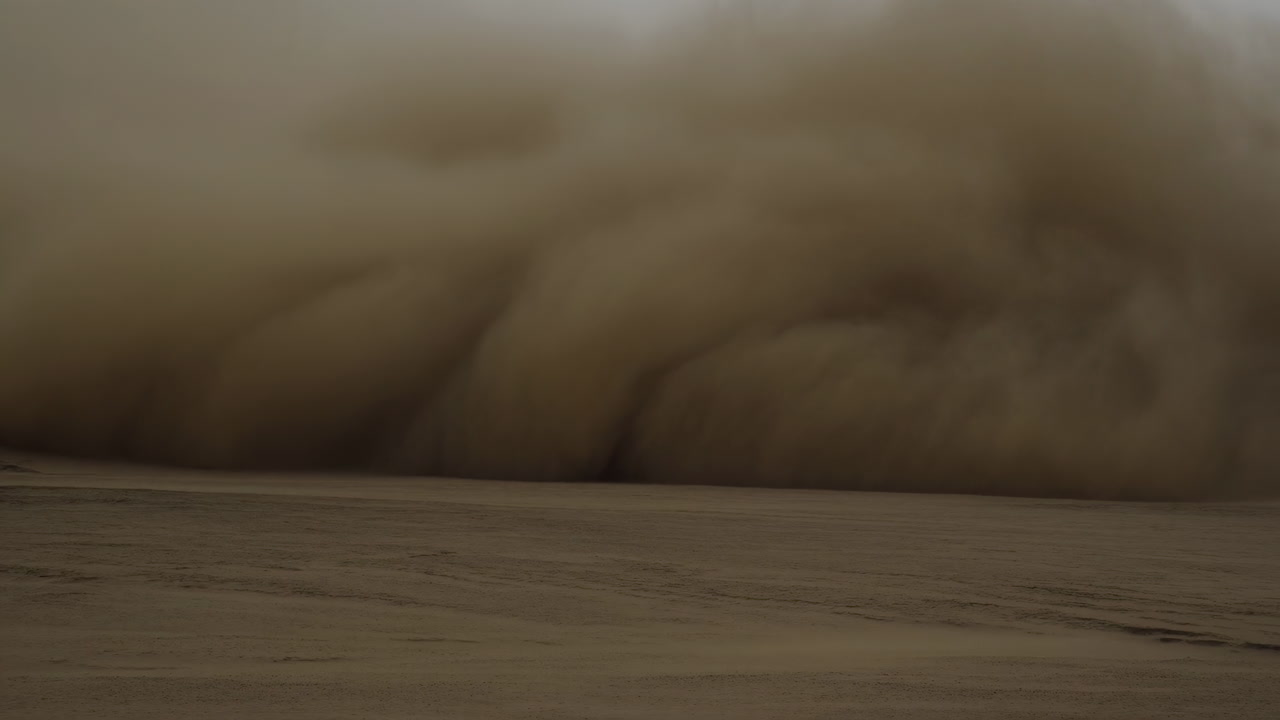 Massive Sandstorm Rolling Across Desert Engulfing Barren Plains With Towering Dust Cloud, Fierce Winds, Low