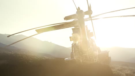 old-rusted-military-helicopter-in-the-desert-at-sunset