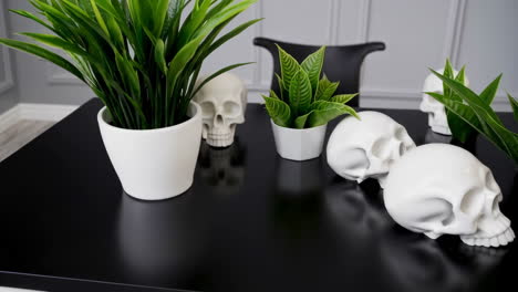 gothic inspired table decor with skulls and potted plants