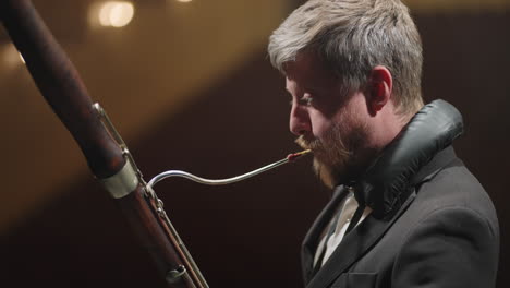 bassoon-player-in-symphony-orchestra-musician-is-playing-classic-music-on-scene-of-theatre-portrait