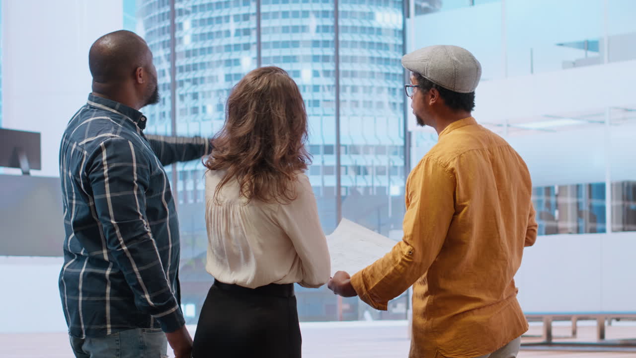 Professional team in a corporate planning session evaluating the blueprints