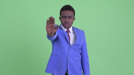 young african businessman with afro hair in suit