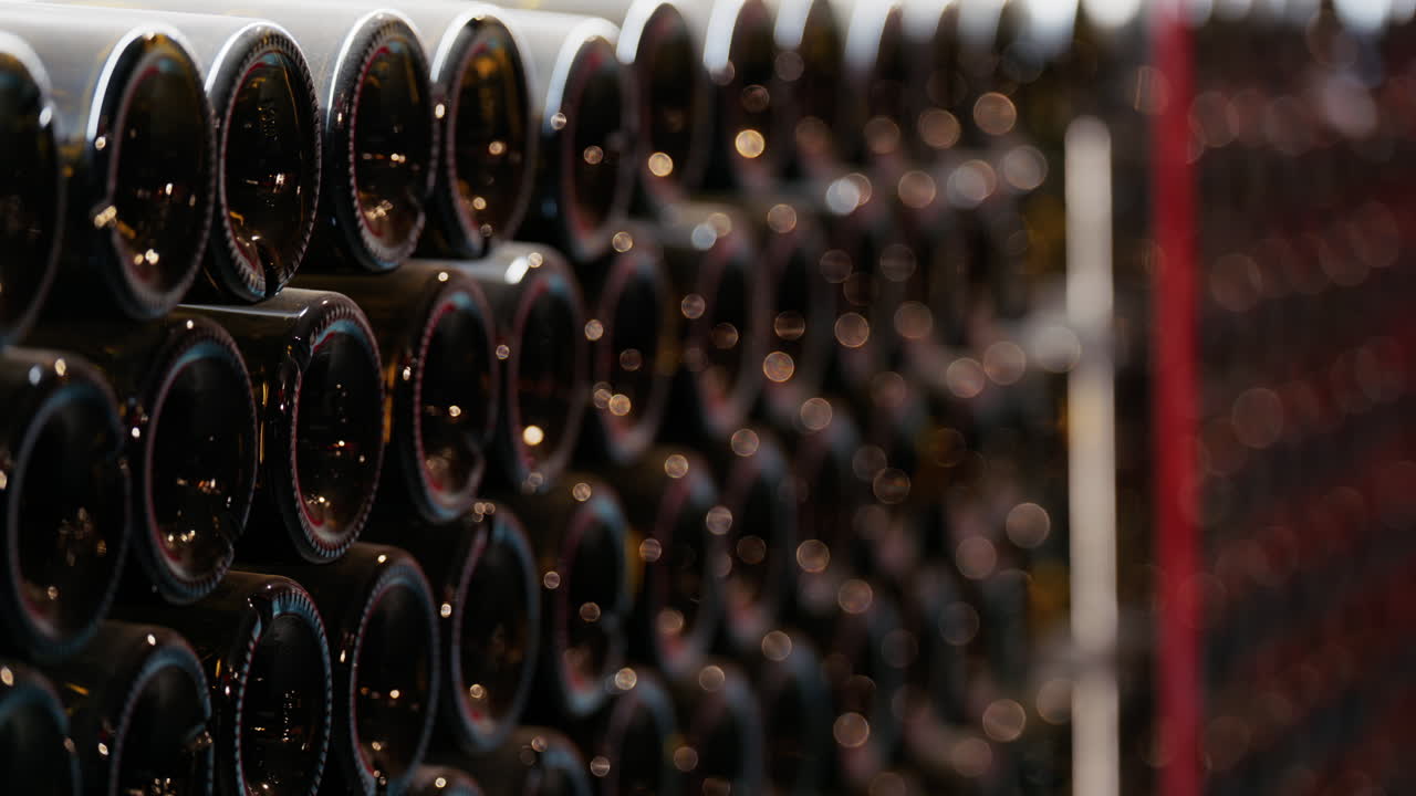 Multiple wine bottles on racks at the Chateau de Cremat winery