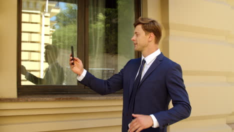 happy business man having video call online outdoors. successful businessman