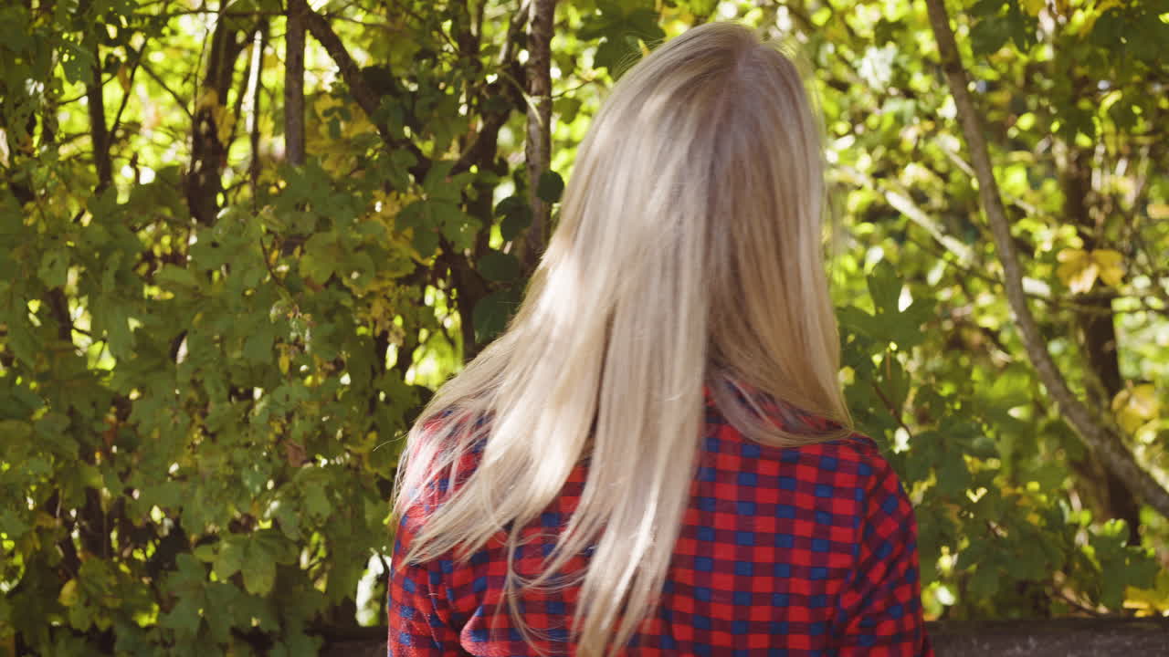 Woman in red plaid shirt enjoying nature