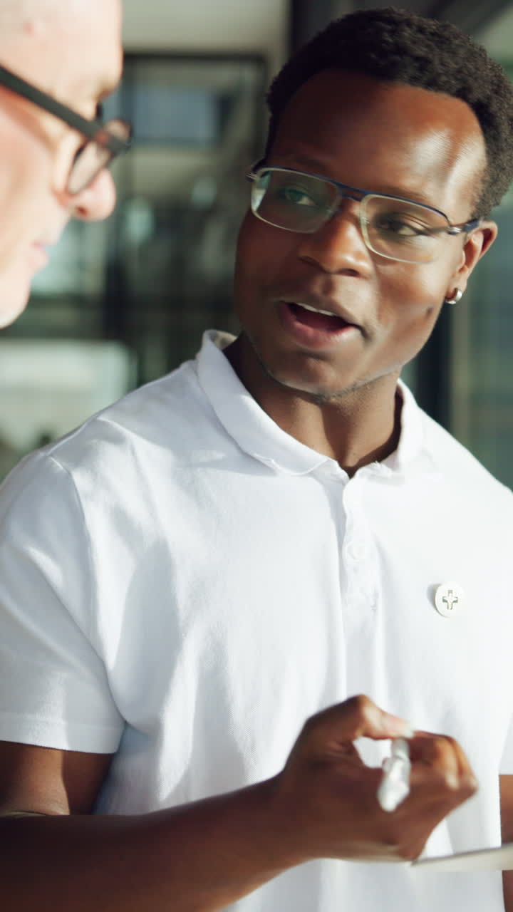 Smiling Young Black Man in Glasses Receiving a Fist Bump