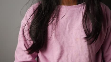 close-up of a girl wearing a pink shirt