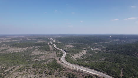 High angle view of cars driving through the Texas Hill Country along the Devil's Backbone