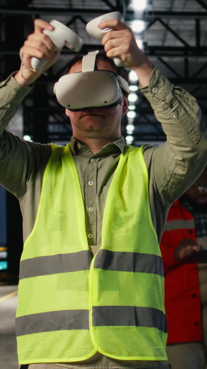 Vertical Video Industrial worker with VR glasses interacting with virtual reality simulation