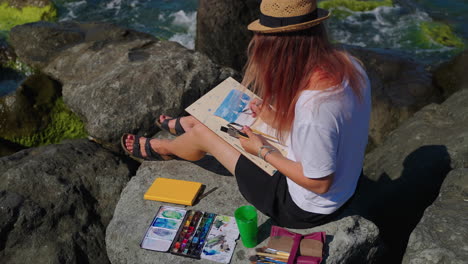 woman painting on the beach