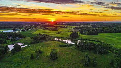 Golden-Sunset-Sky-Over-Countryside-Landscape-With-Ponds-And-Lakes