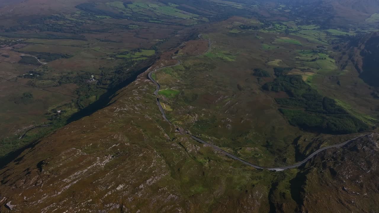 Caha Pass, County Cork, Ireland, September 2024. Drone stunning overview from high angle perspective of winding mountain road crossing the border with County Kerry.