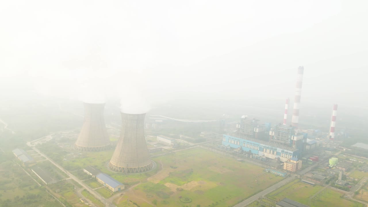 Aerial capture of industrial plants in India, highlighting emissions from multiple smoke chimneys.
