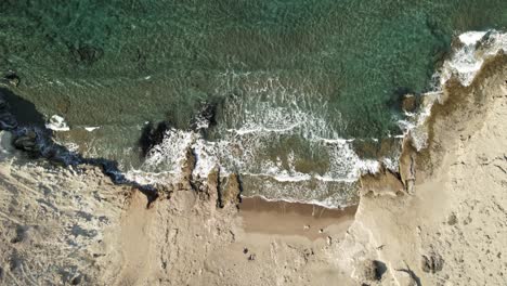 sparkling, crystal-clear waves gently roll onto lonely beach in greece