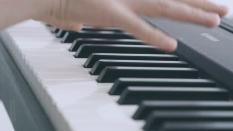 Detail-of-keys-of-an-electric-piano-played-by-two-hands