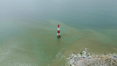 Revealing-video-of-Beachy-Head-Lighthouse,-white-cliffs-and-sea-taken-by-dji-mini-3-pro-drone-in-Eastbourne-England