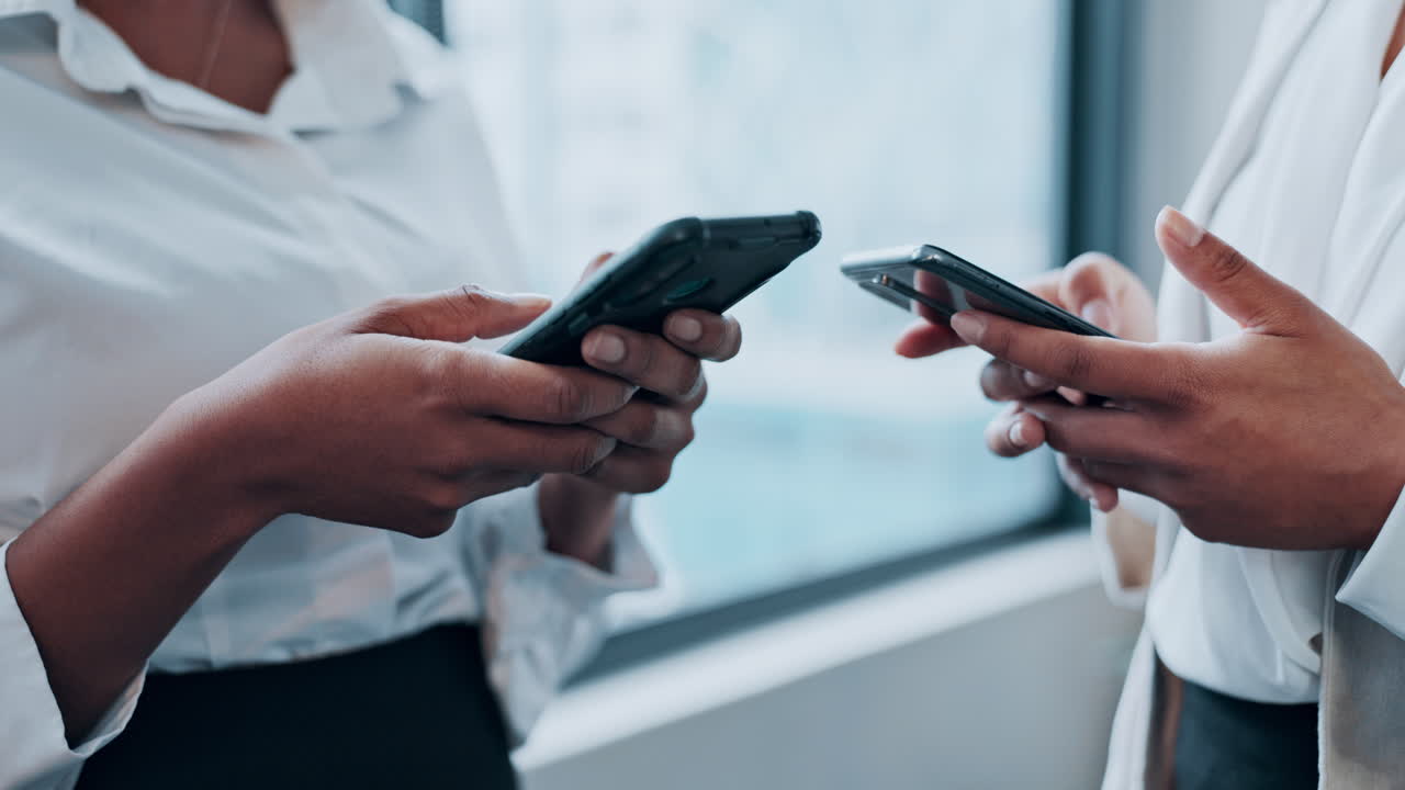 Two Businesswomen Using Smartphones
