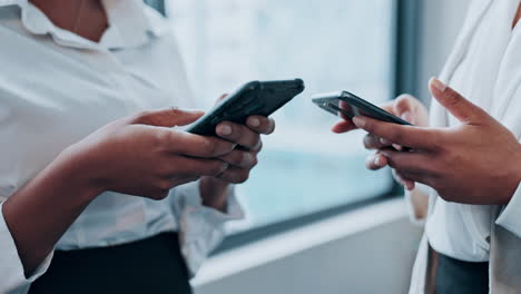 two businesswomen using smartphones