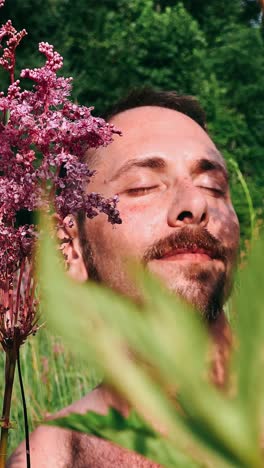 man relaxing in a meadow with flowers