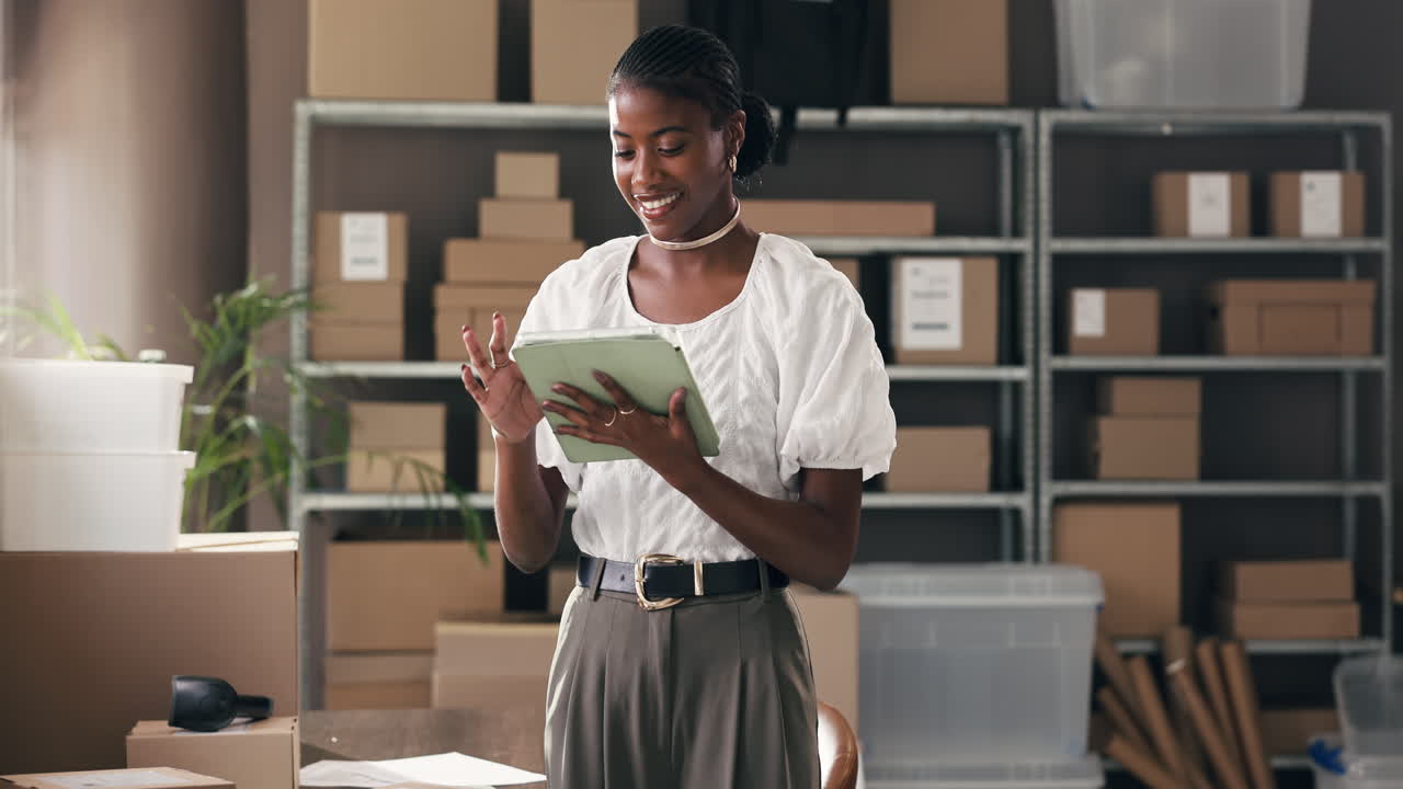 Happy Young Black Woman Using Tablet in Small Business Warehouse