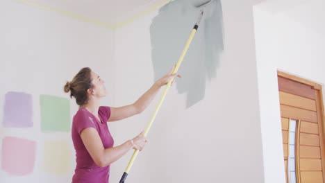 portrait of a caucasian woman in quarantine during coronavirus pandemic, doing interior work