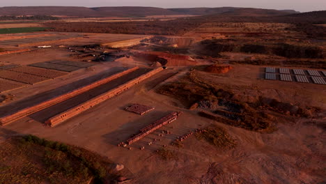 sunset aerial view over clay brick factory with smoke rising from clamp kiln