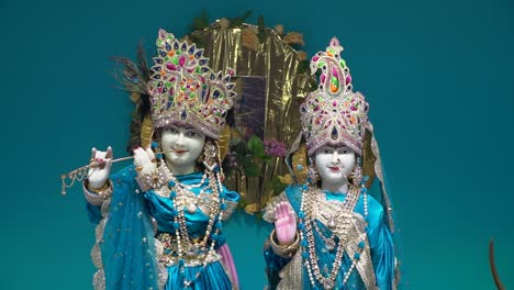 close up of statues of hindu gods krishna and radha in temple