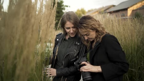 two women photographers in a field