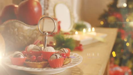 Animation-of-decorated-christmas-tree-and-table-with-christmas-desserts