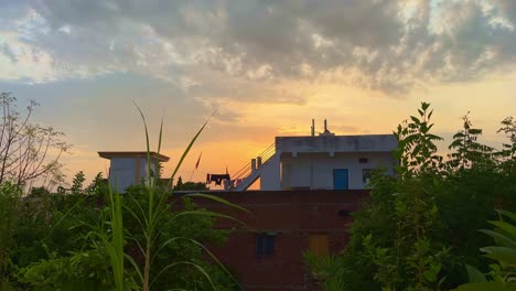a beautiful morning at the farm house, tilt down shot showing a few moment before the sunrise with the golden sky and few cloud
