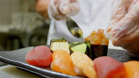 Male-chef-preparing-sushi-in-kitchen-4k