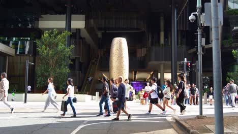 Slow motion shot of people crossing the streets in Brisbane city, featuring Lindy Lee’s masterpiece, Being Swallowed by the Milky Way at George Street entrance to Queen's Wharf precinct.