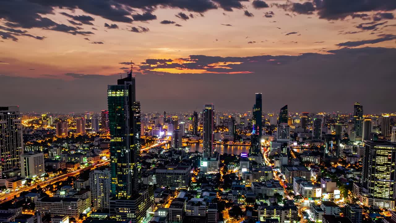 Aerial video showcasing a bustling cityscape at dusk, highlighting vibrant lights and towering