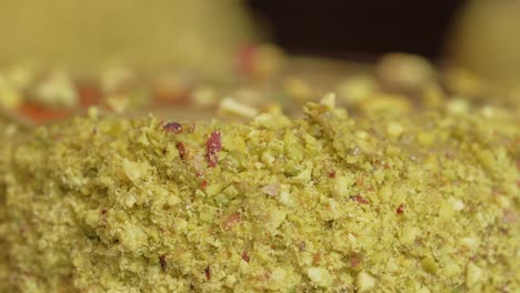 pistachio donut being decorated close up nuts