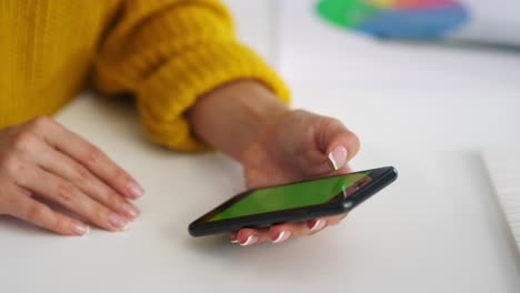 businesswoman looking green screen mobile. unrecognized girl surfing internet