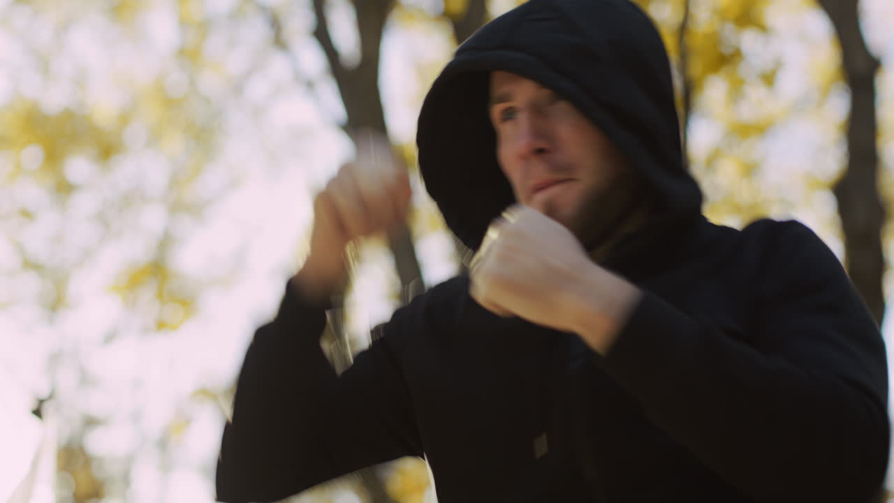 Man practicing martial arts in a park