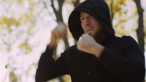 man practicing martial arts in a park