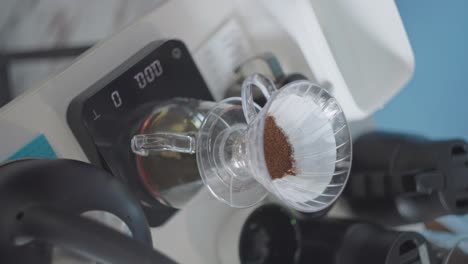 Vertical,-fresh-coffee-grounds-in-filter-of-v60-drip-brewer-on-precision-scale