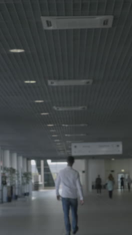 blurred indoor hallway with people walking