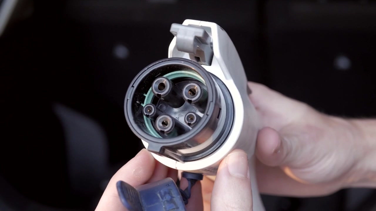 Plug that charges electric cars. Car charger. Electric car. Charging of eco friendly electric car