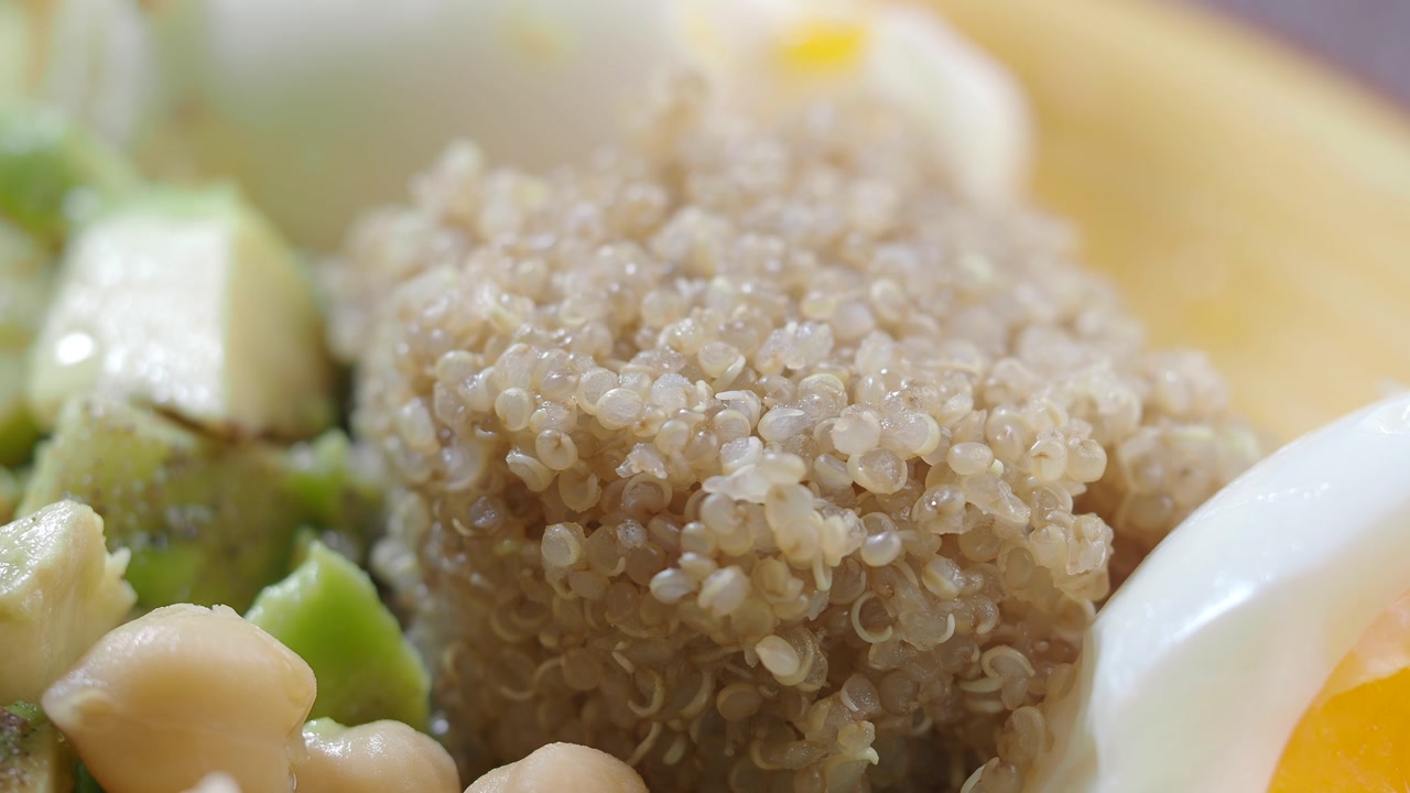 Close Up of Healthy Meal with Quinoa, Egg, Avocado, and Chickpeas
