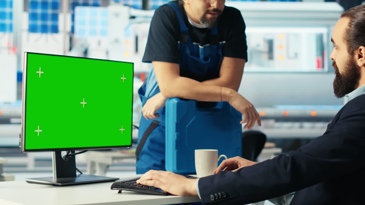 el gerente de la fábrica de fotovoltaica hablando con un empleado, usando una computadora de pantalla verde