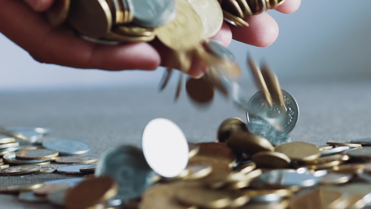 Businessman holding coins in his palms. Slow motion