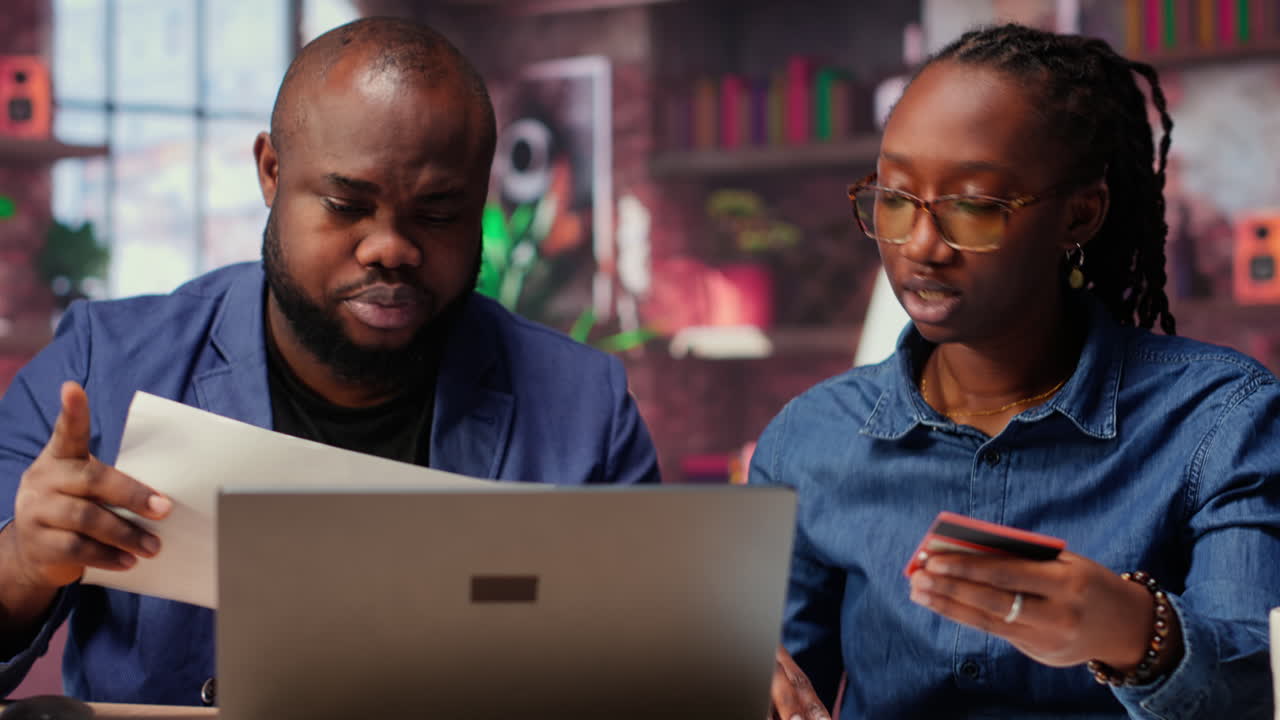 Relaxed people entering card numbers to verify the balance before paying online